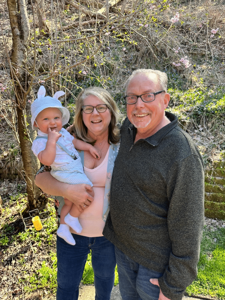 Debbie, Alan, and their grandchild. Photograph provided by Debbie Pritts.