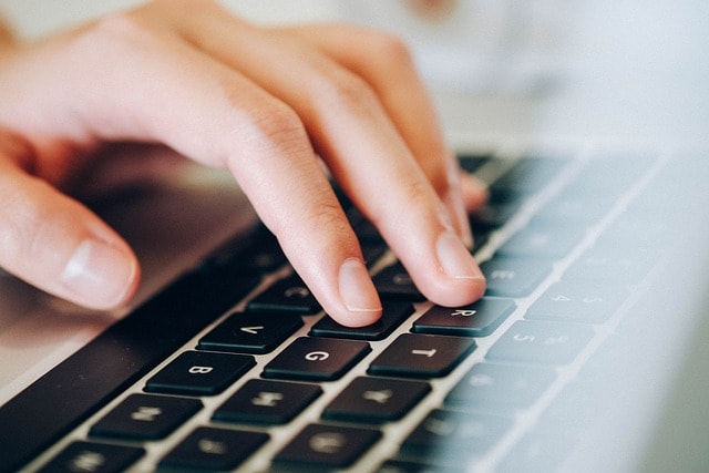 A hand on a keyboard.