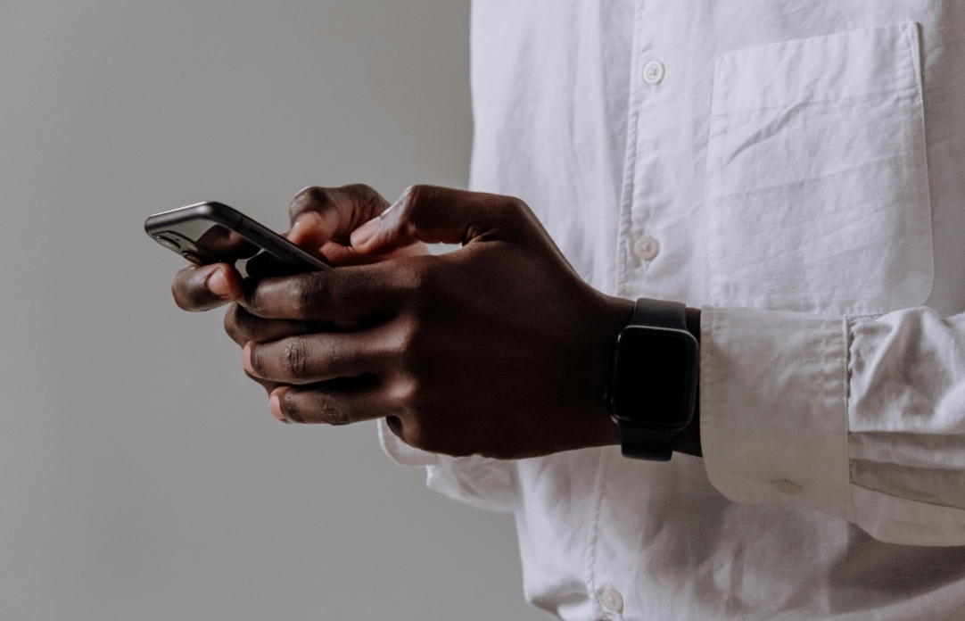 Person in White Dress Shirt Holding Black Smartphone