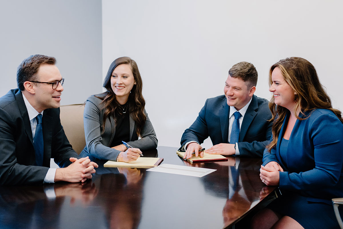 Four employees gathered inside Conference Room