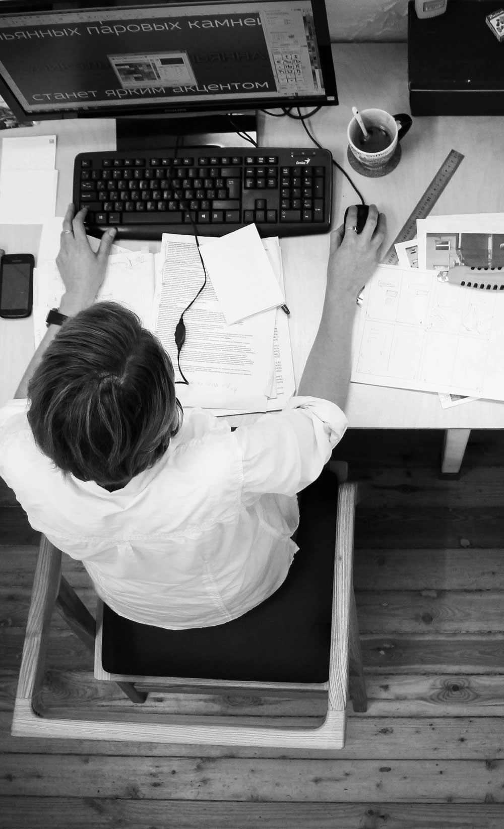 Black and Gray Photo of Person in Front of Computer Monitor