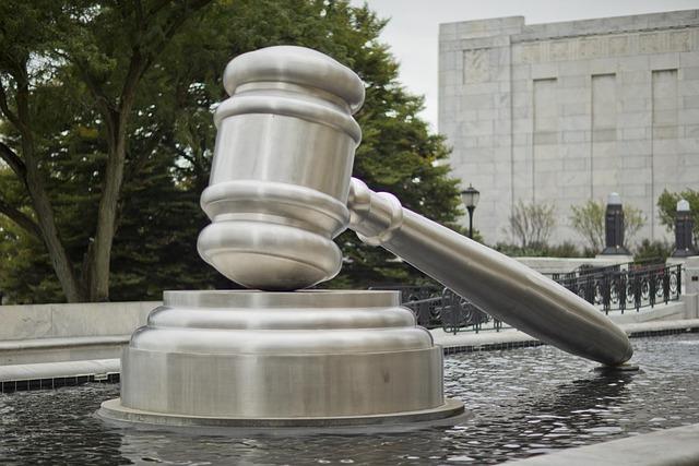 A large silver sculpture of a gavel.