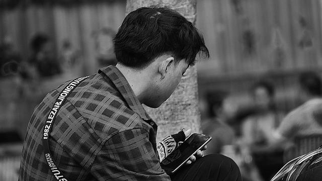 A teenager on his phone.